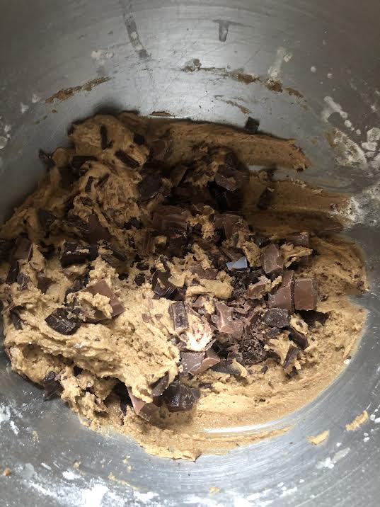 Cookie dough with chocolate chips in bowl of stand mixer