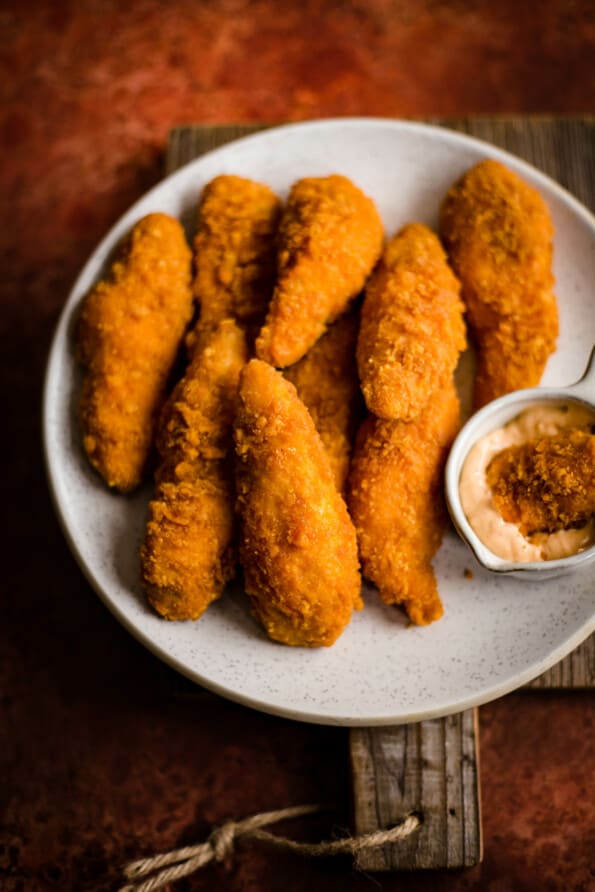Chicken Goujons on a plate with dipping sauce to side