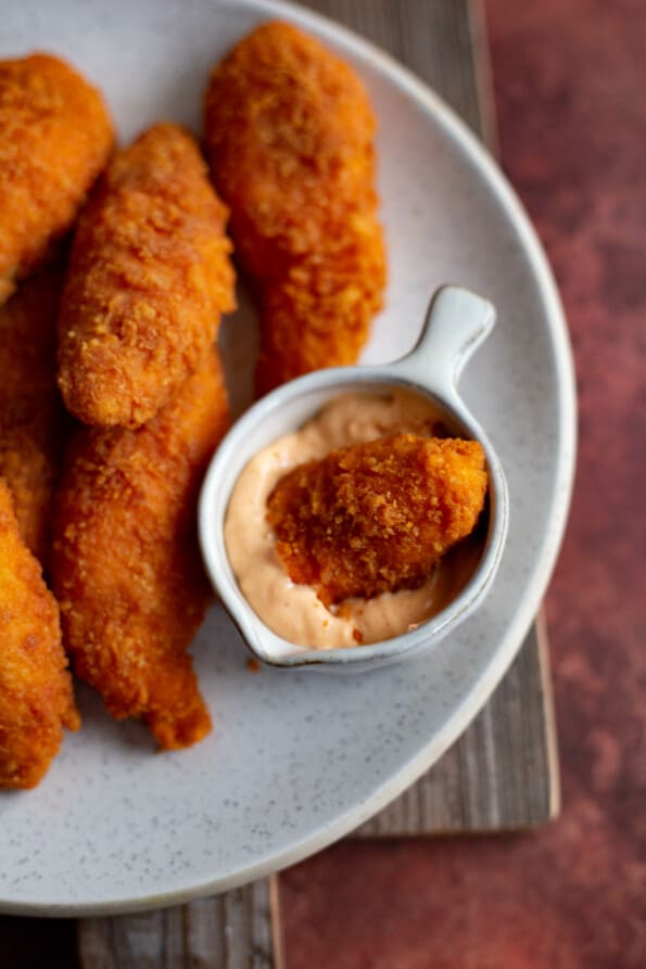 Chicken Goujons in a plate with dipping sauce to side
