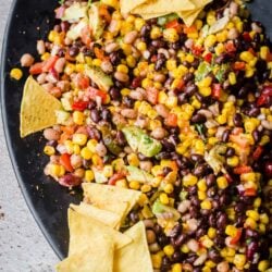 Cowboy Caviar Salad in a large oval dish with Nachos