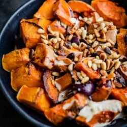 Pumpkin salad with pine nuts and tahini dressing in a bowl