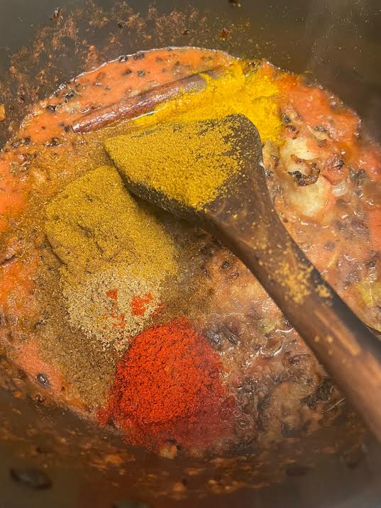 Ground spices added to pot