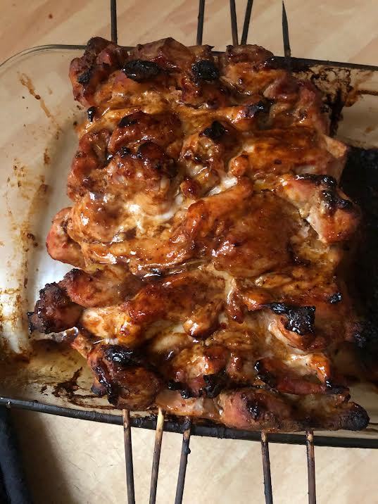 Cooked Chicken on skewers in oven dish