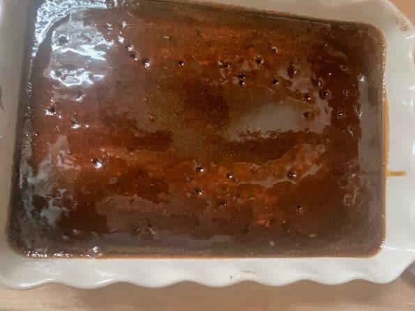 Sticky toffee cake with toffee sauce in dish