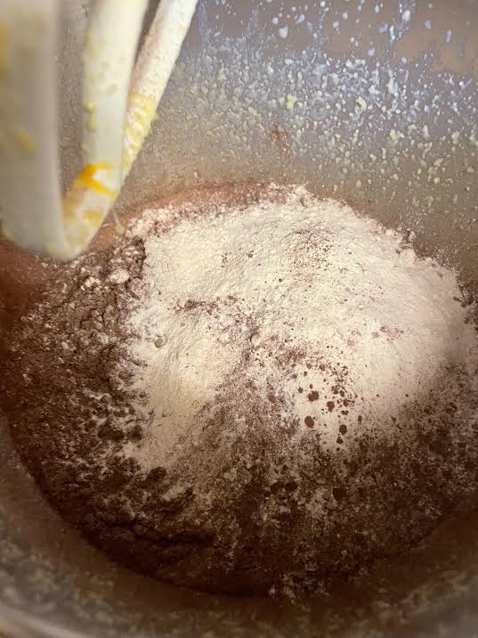 Plain flour added to batter in bowl