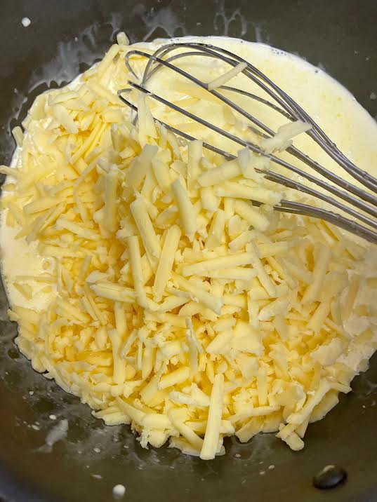Grated cheese added to pot
