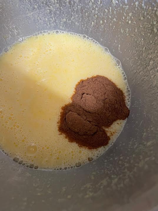 Cocoa and Malt powder added to batter in bowl