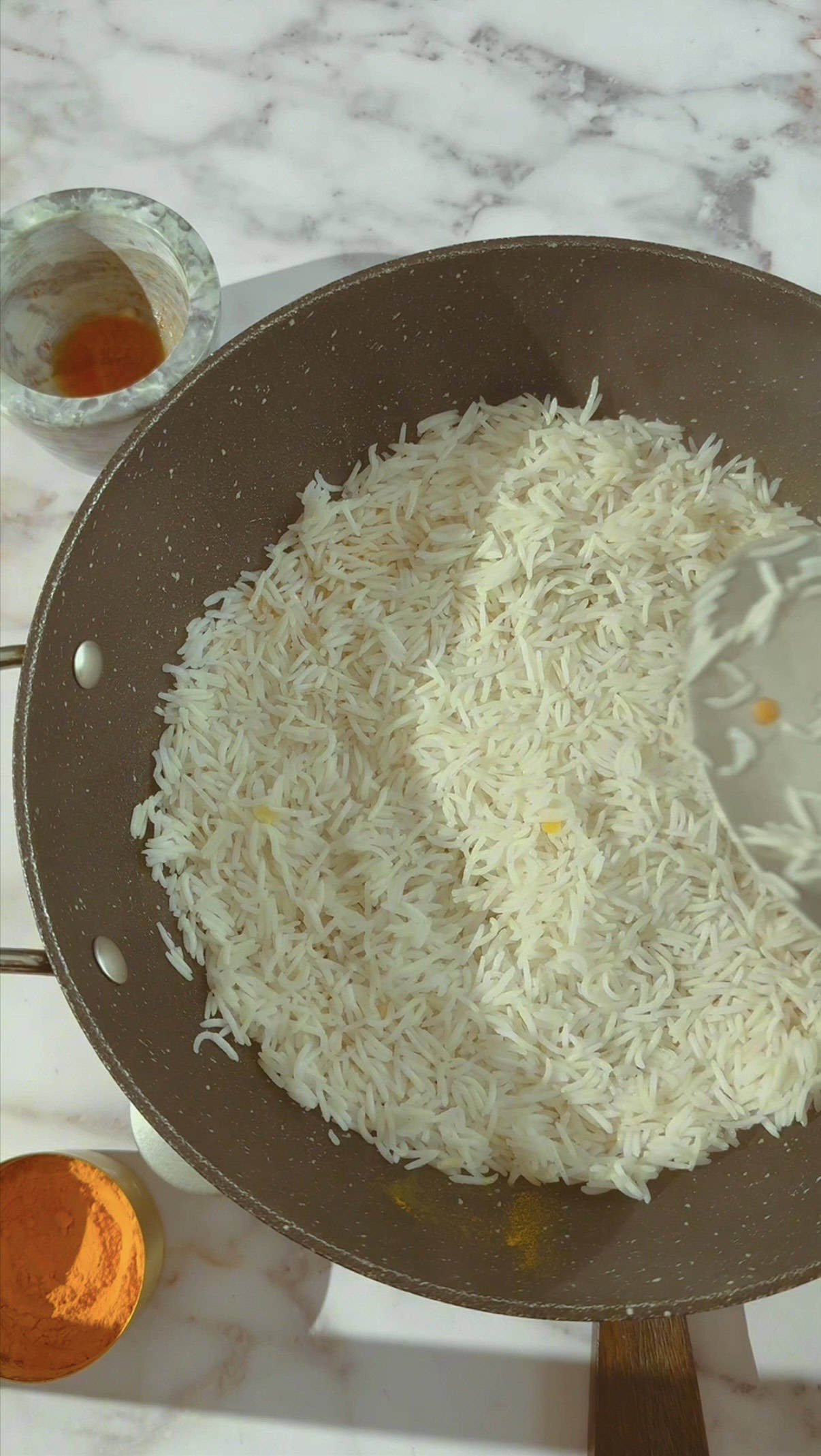 Golden Tahdig (Persian Crispy Rice) - Foolproof and Authentic Rice being spread on bottom of pot