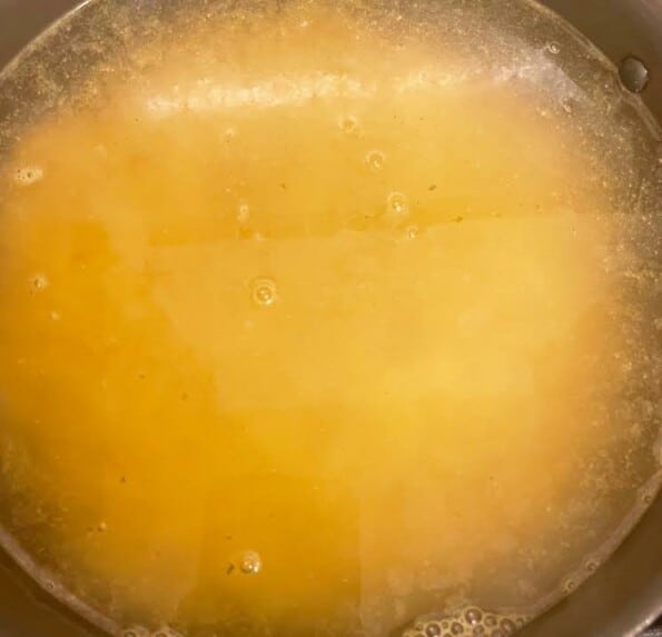 Macaroni and stock in pot