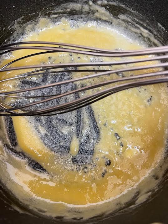 Butter and flour with whisk in pot