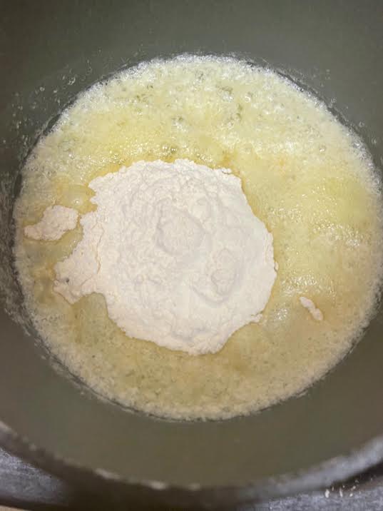 Flour added to butter in pot