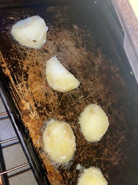 Potatoes added to hot oil in oven