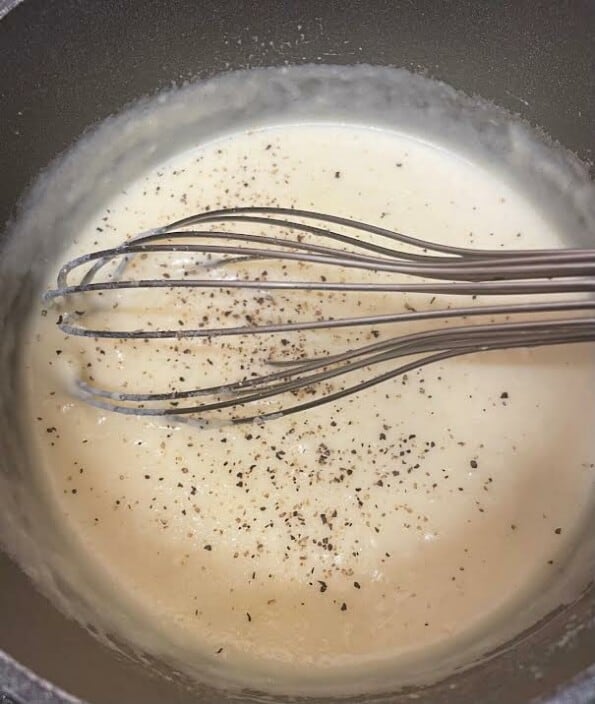 Sauce being whisked on stove