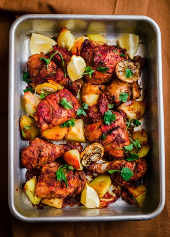 Tandoori chicken and potatoes in a tray