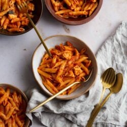 5 bowls of penne Pomodoro with cutlery