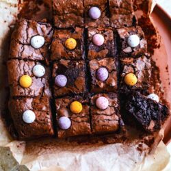 Mini Egg Brownies cut into squares on baking paper