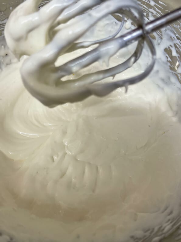 Filling in stand mixer with soft peaks visible