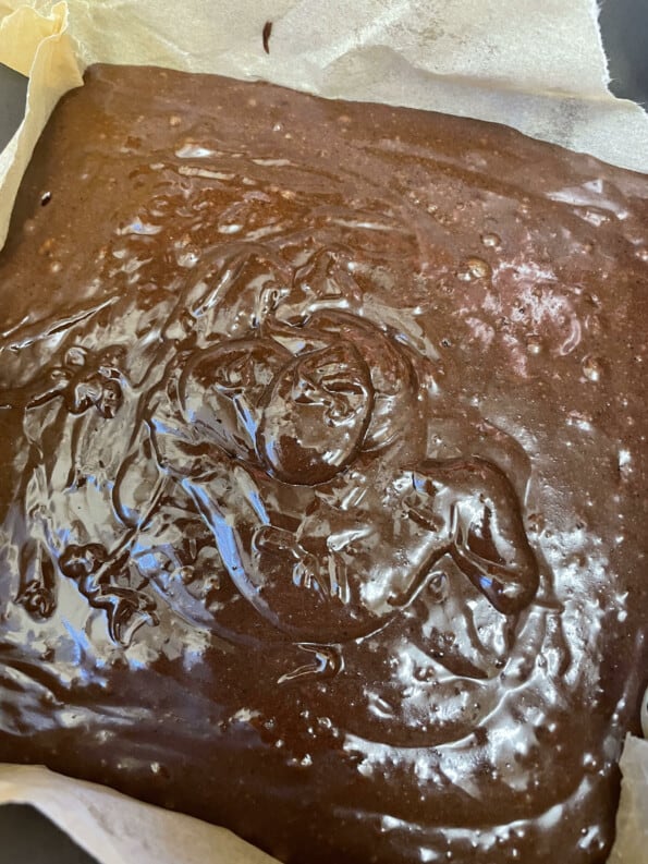 Brownie batter in lined tin