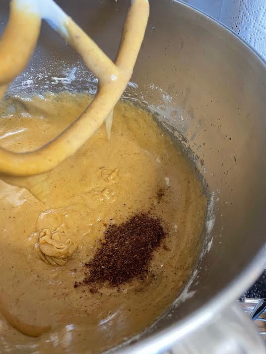Star anise powder added to bowl of stand mixer