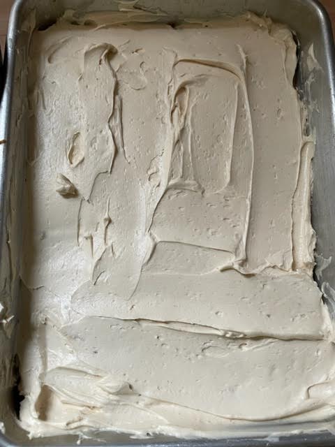 Final cream layer added on top of tiramisu