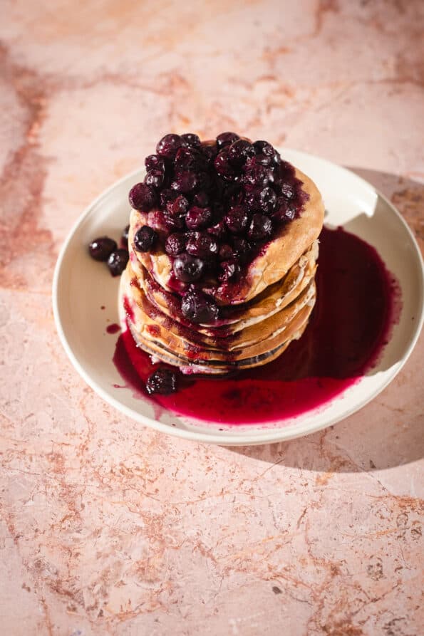 Oat milk pancakes with blueberry compote in plate