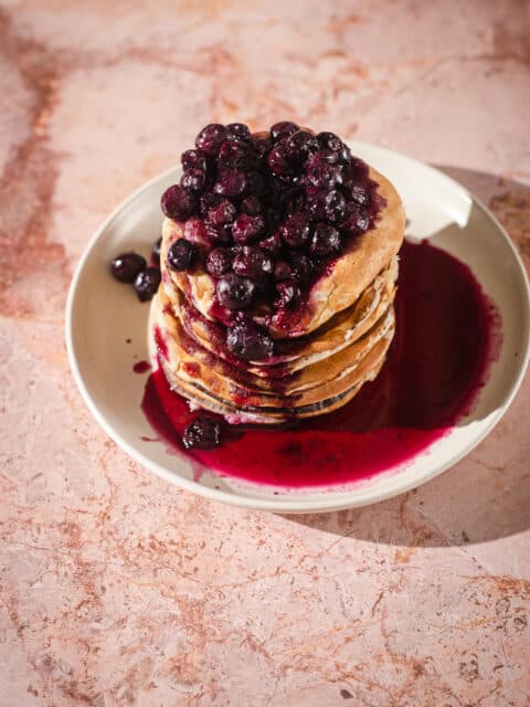 Stack of pancakes with blueberry compote on top
