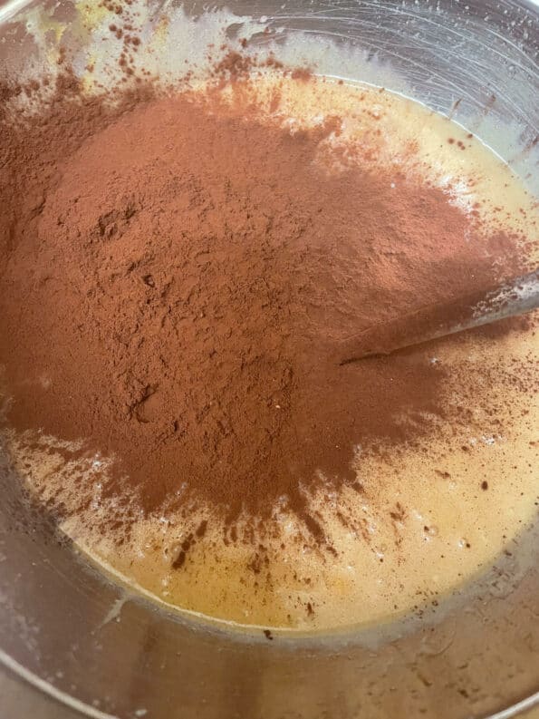 Cocoa powder added to brownie batter bowl