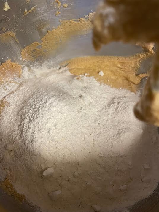 Flour added to cake batter in bowl
