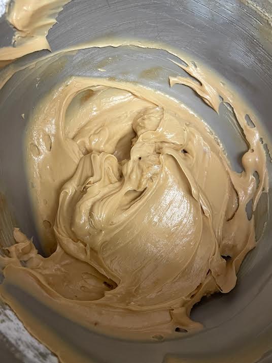 Smooth cream cheese frosting in a bowl