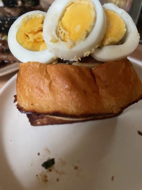 Egg slices added to top of sandwich 