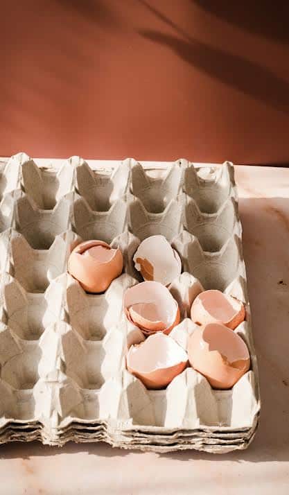 Cracked eggs in an egg tray