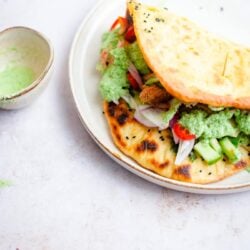 Naan-Wich on a plate with sauce in a bowl at side