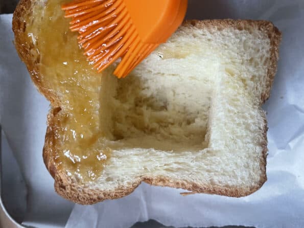 Honey butter being basted onto Shibuya toast