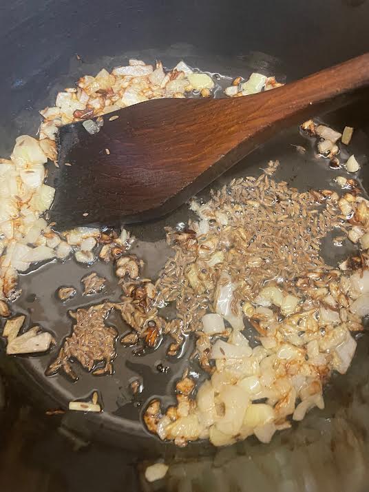 Onions and cumin seeds in pot