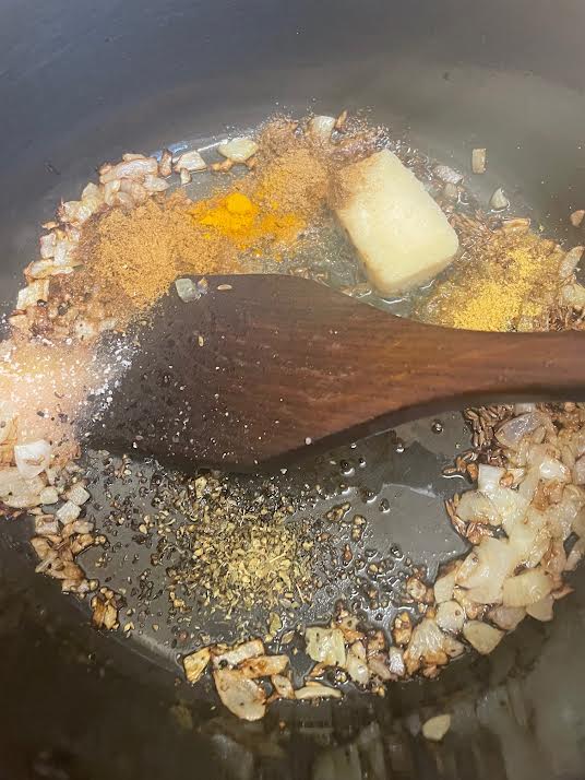Ground spices added to pot