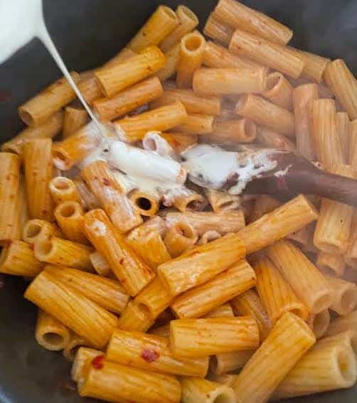 Cream added to pasta in pot