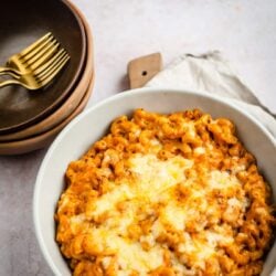 Masala macaroni in dish with bowls to side