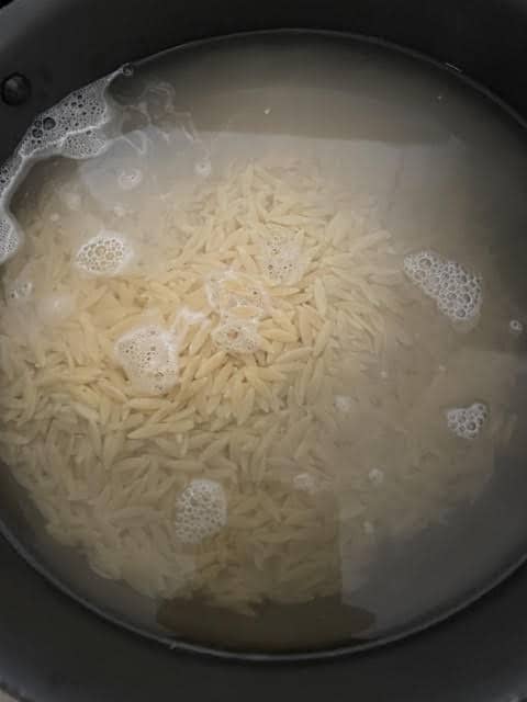 Orzo in water in pot