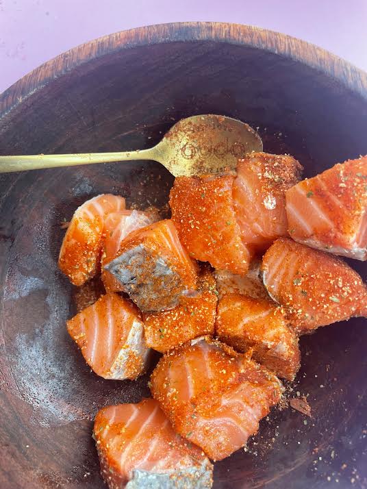 Salmon with cajun seasoning in a bowl