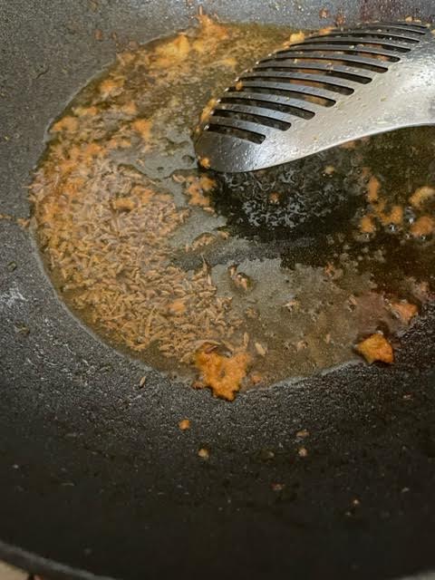 Cumin Seeds added to oil in wok