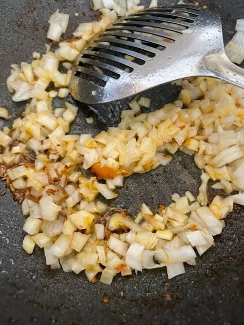 Onions added to oil in wok