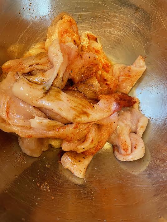 Chicken in marinade in bowl