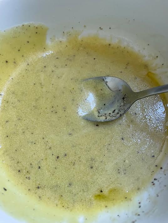 Mixed dressing in bowl with spoon