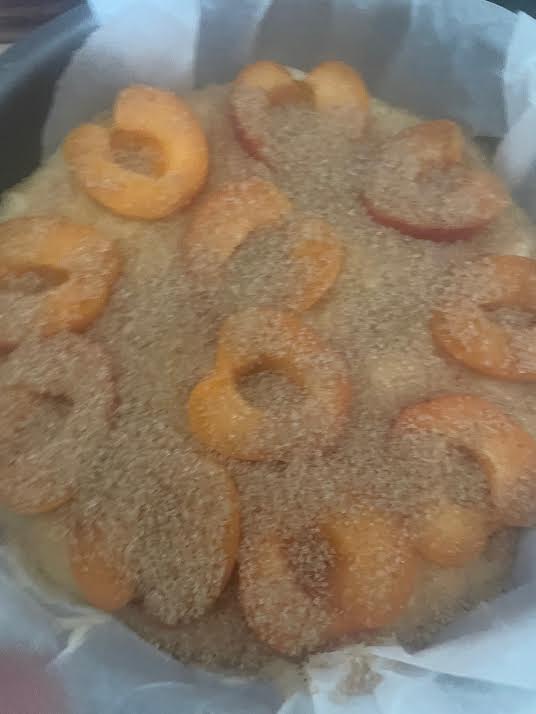 Apricots added to cake batter in tin