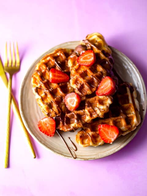 Croissant waffles in a plate with strawberries and chocolate 