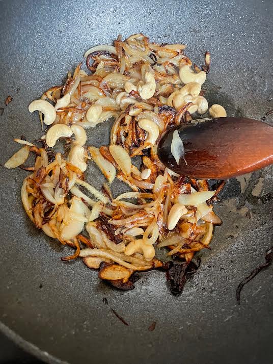 Onions ans Cashews in a wok
