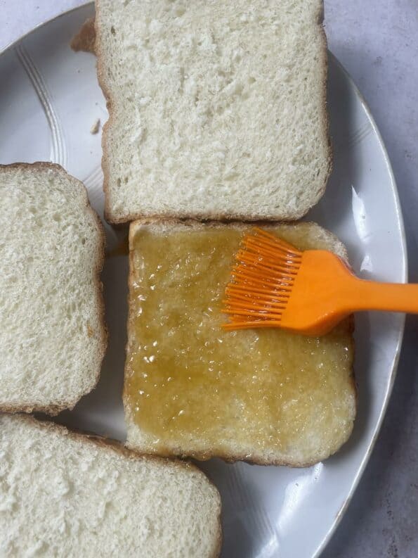 Bread being brushed with Honey Butter mixture
