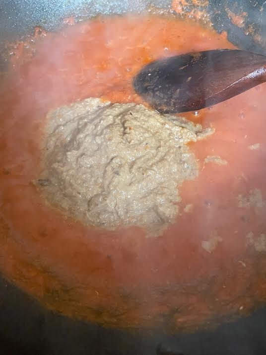 Cashew Paste added to tomatoes in wok