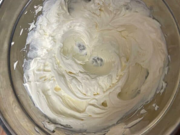 Whisked cream cheese in a bowl