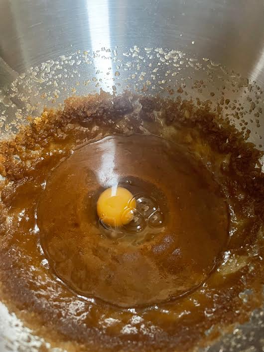 Egg added to batter in bowl of stand mixer